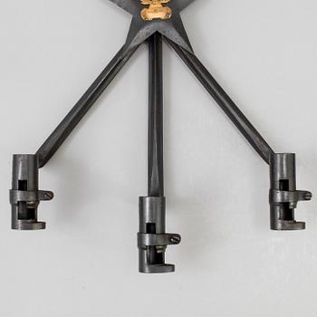 A pair of steel wall sconces made from bayonets, 20th Century.