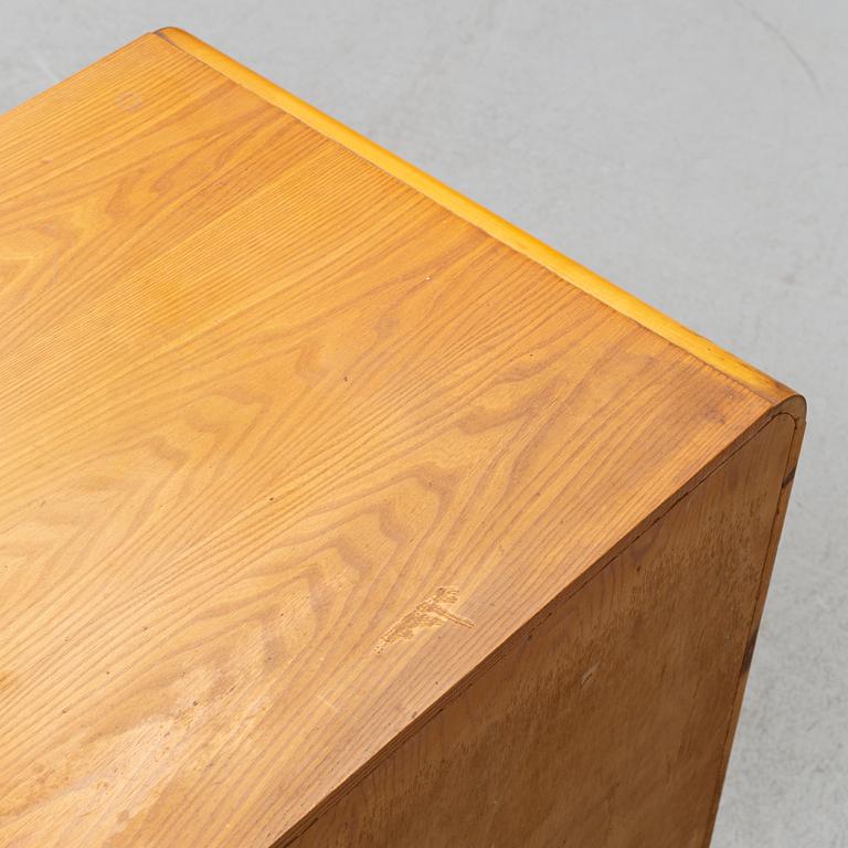 An elm wood venered chest of drawers mid 20th century.