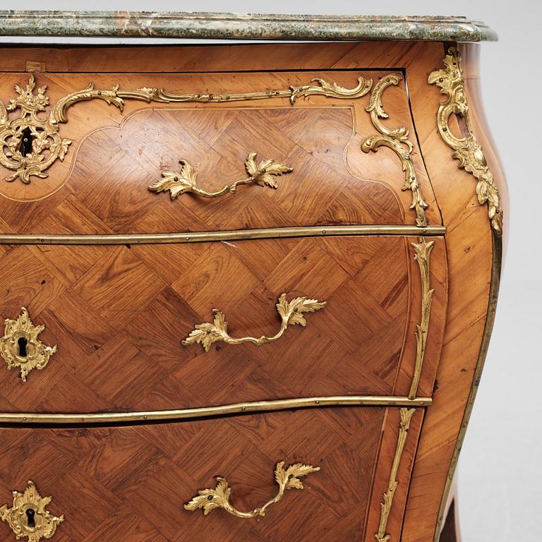 A rococo parquetry and gilt brass-mounted commode by J. J. Eisenbletter (active ca 1760-1810).