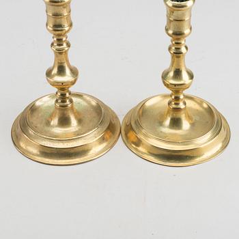 A set of two of brass candle sticks mid 18th century.