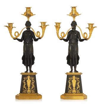 117. A pair of French Empire patinated and ormolu three-light candelabra, Paris, early 19th century.