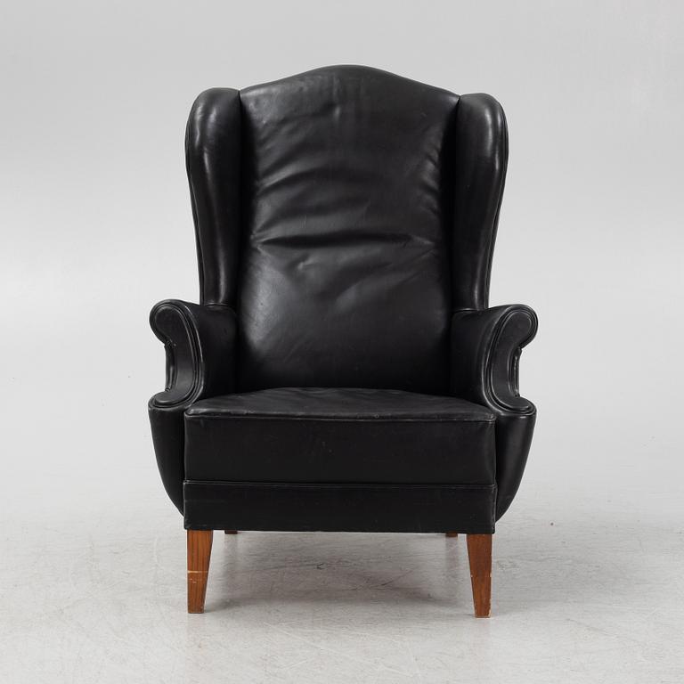 A leather upholstered wingback chair, 20th Century.