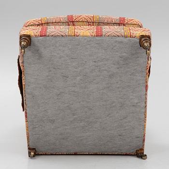 A Howard armchair with ottoman.