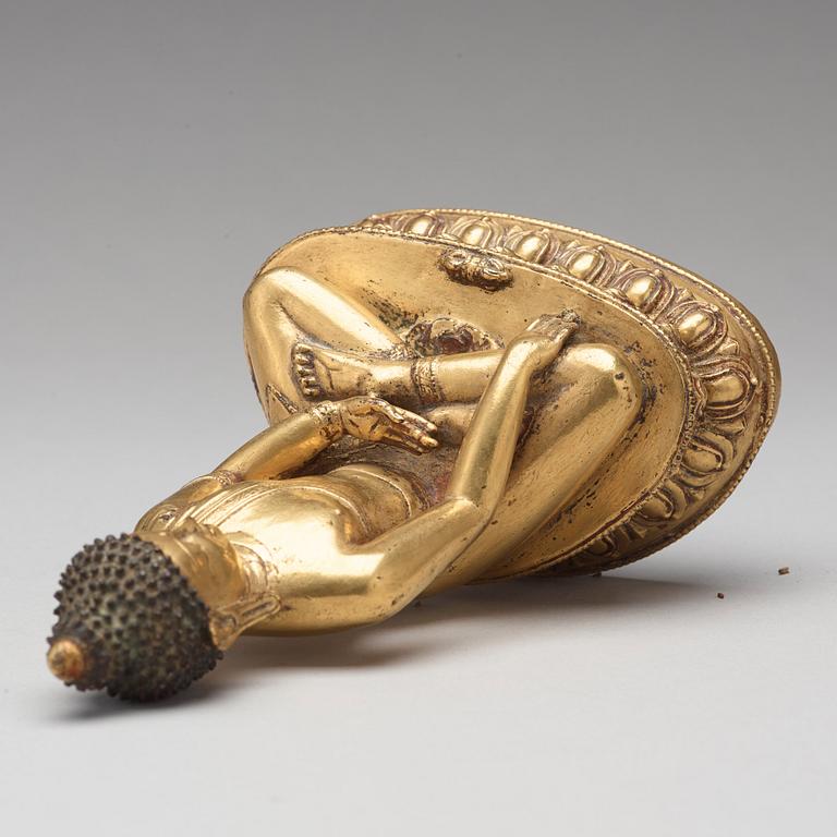 A gilt copper alloy figure of Akshobhya, Tibet, 16th Century.