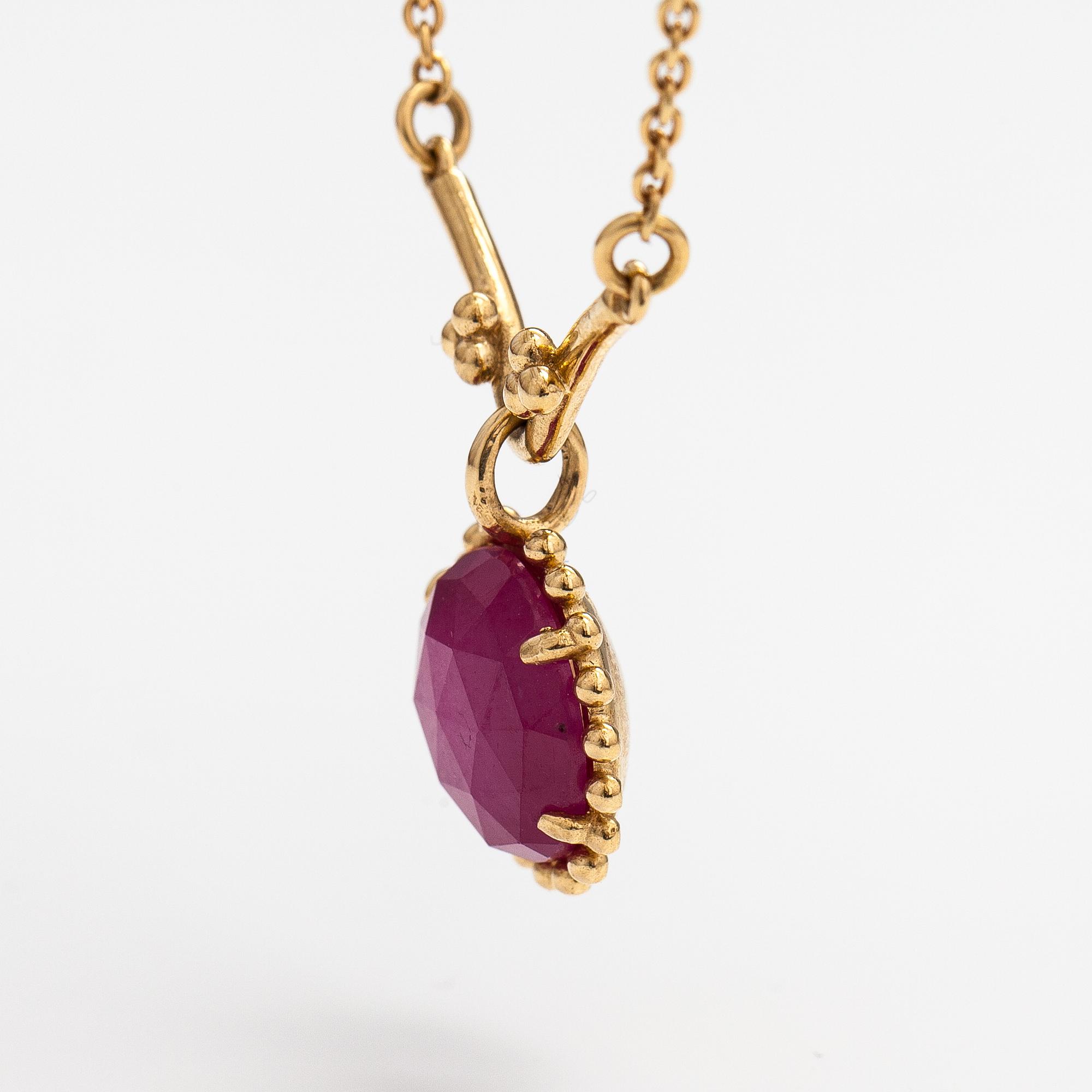 Pandora, a necklace with a lead glass treated ruby.