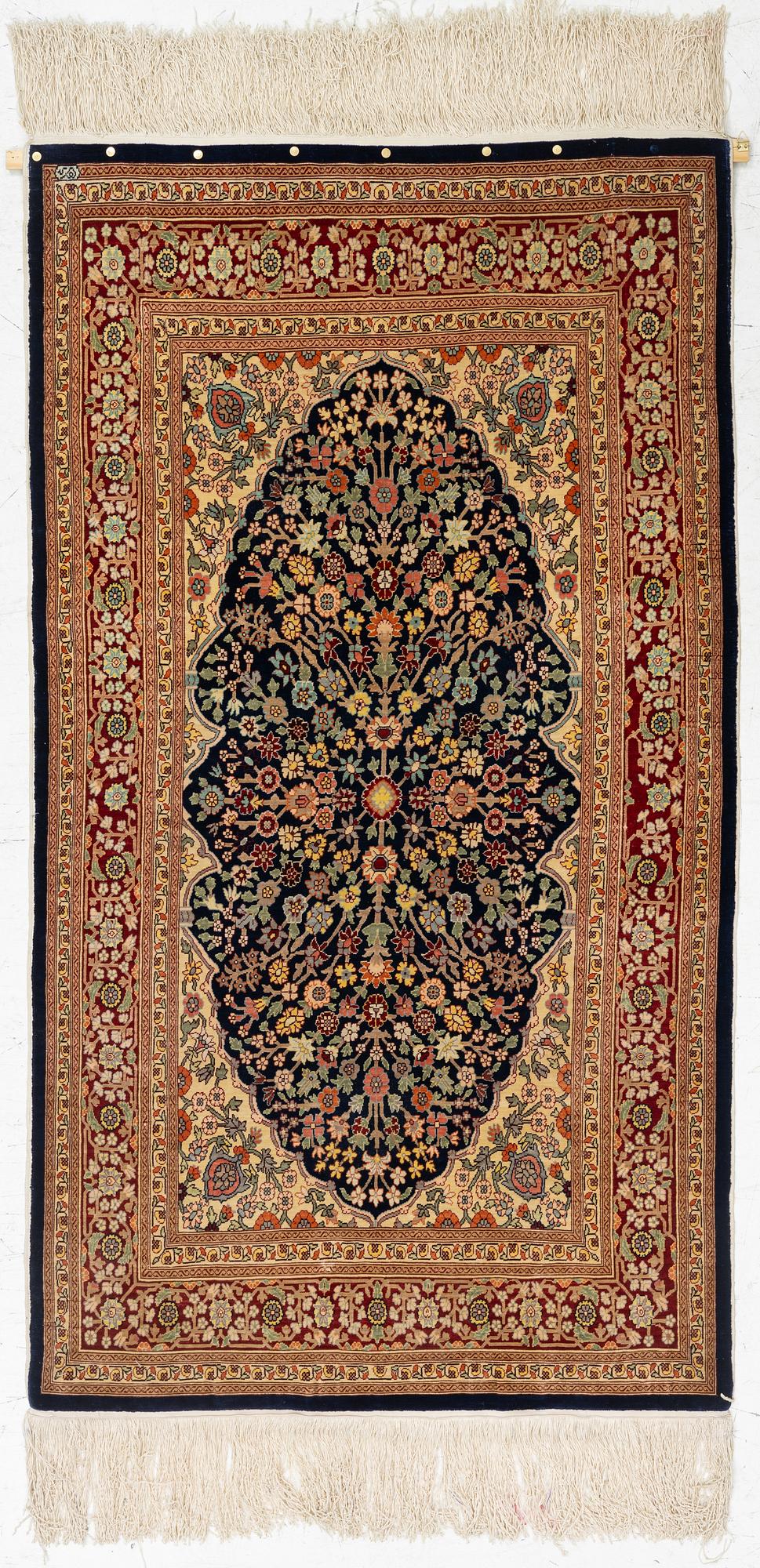 A Hereke silk rug, c. 130 x 71 cm.