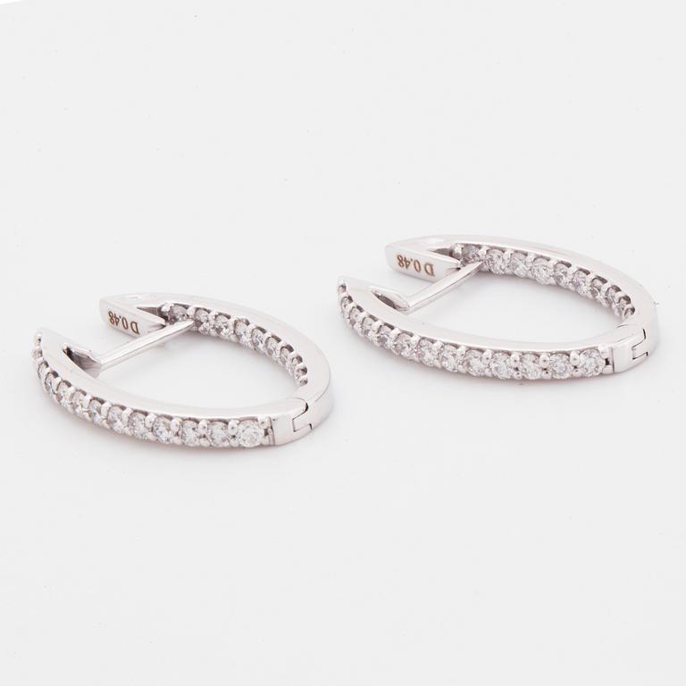 Brilliant-cut diamond hoop earrings.