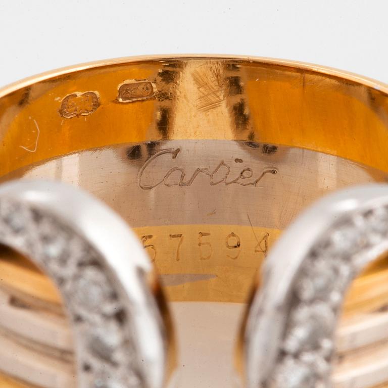 A Cartier "Double C" ring in 18K tri color gold set with round brilliant-cut diamonds.