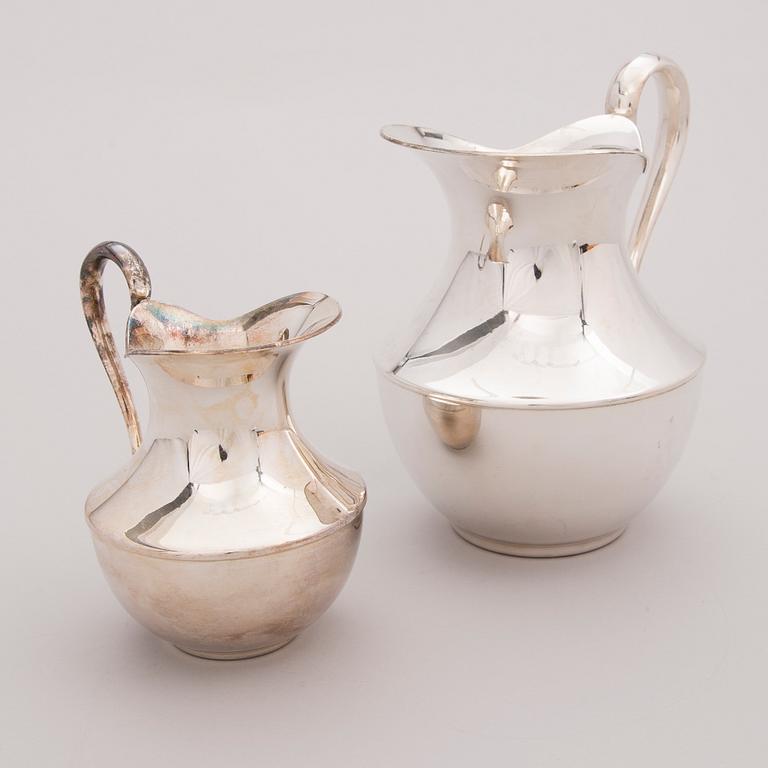 Two late 20th century white metal tankards.