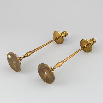 A pair of model 2539 brass candlesticks, for Firma Svenskt Tenn, designed ca 1949-50.