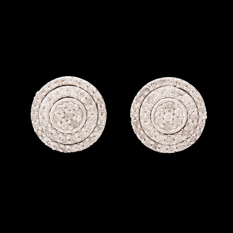 A pair of 14K white gold earrings set with round single-cut diamonds.
