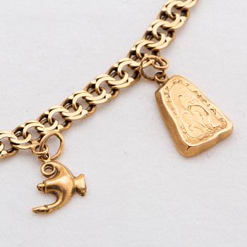 AN 18K gold bracelet with berlocks total weight ca 11,6 gr.