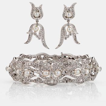 A platinum bracelet and a pair of earrings set with pearls and old-, eight- and rose-cut diamonds.