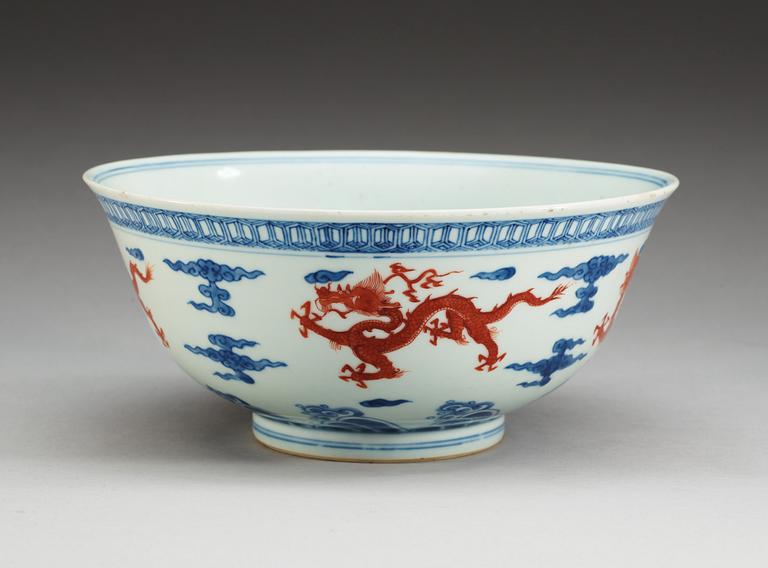 A blue and white bowl with a dragon in copper red, Qing dynasty with Xuande six character mark.