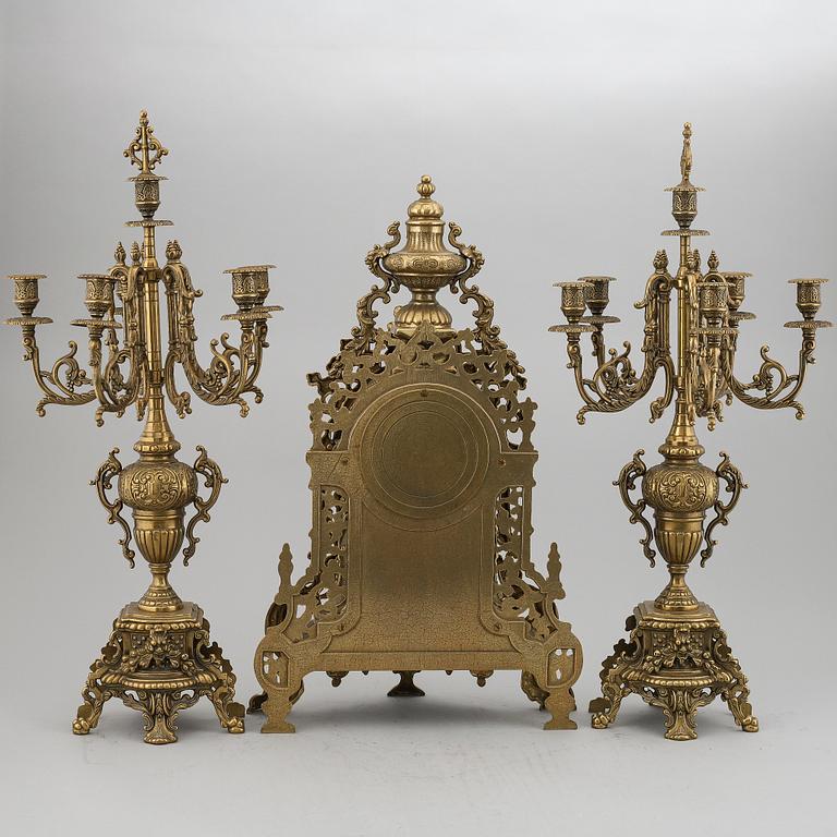 A 20th Century set of a brass mantle clock and a pair of candelabras.