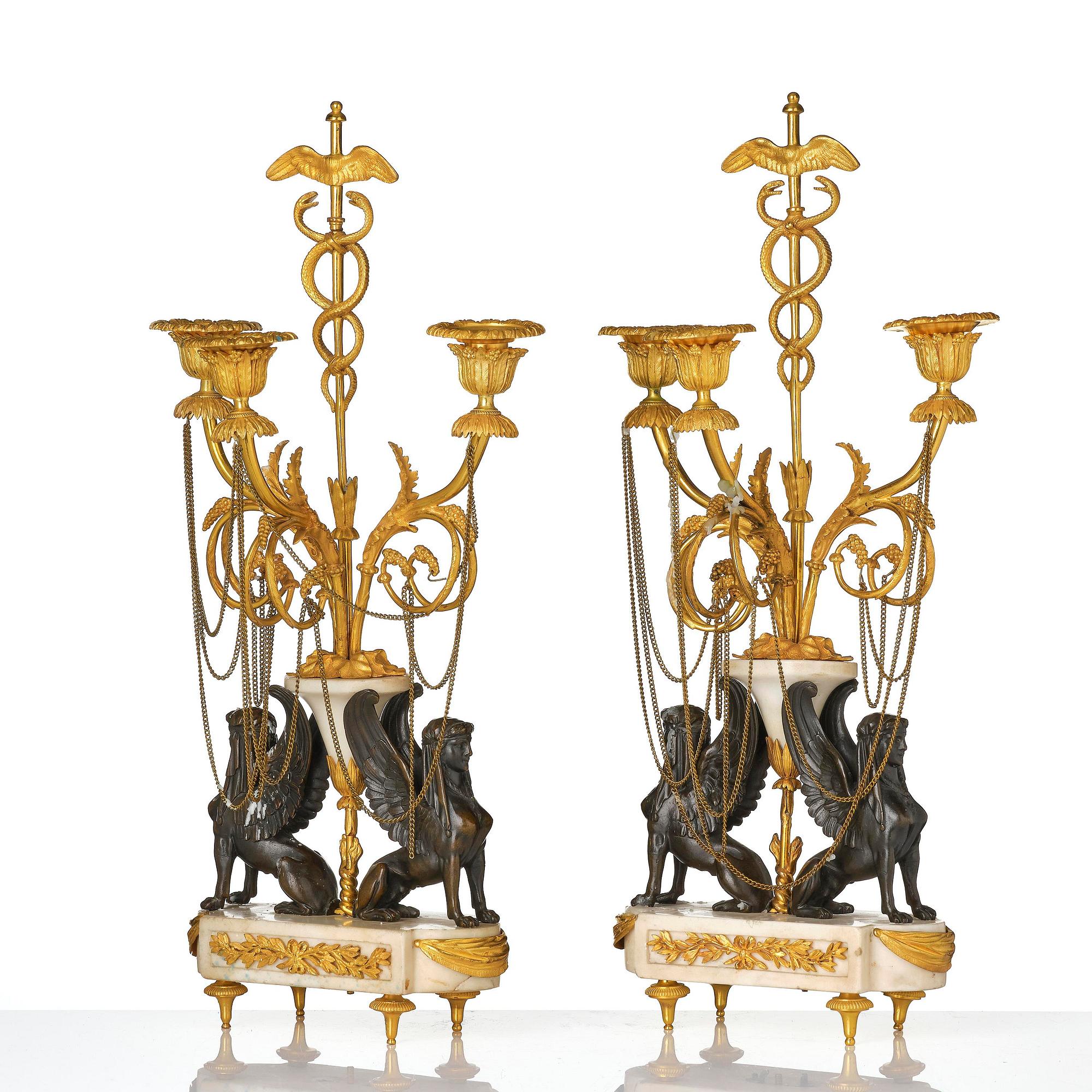 A pair of Louis XVI three lights Candelabra, Parisian works, in the manner of François Rémond, late 18th century.