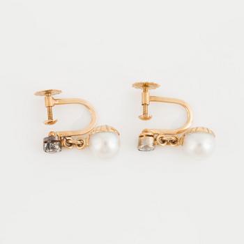 A pair of earrings set with cultured pearls and old-cut diamonds.