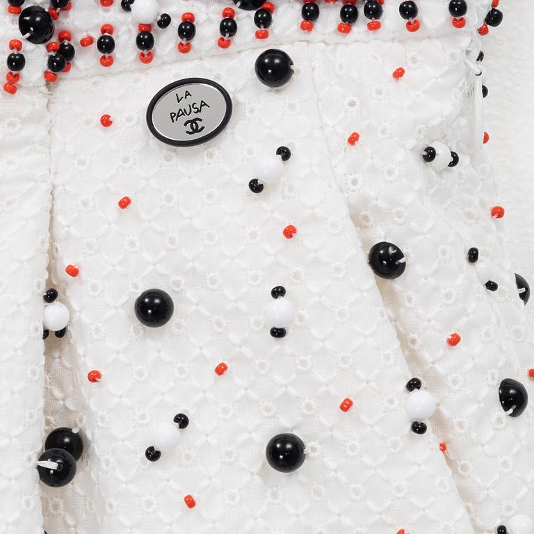 Chanel, a pair of broderie anglais trousers with pearls, size 34.