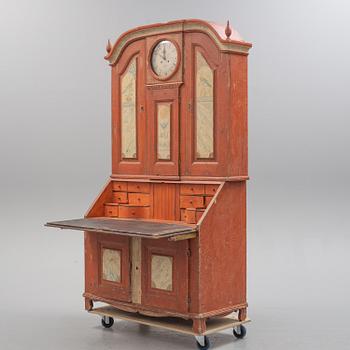 An end of the 18th century cabinet with clock.