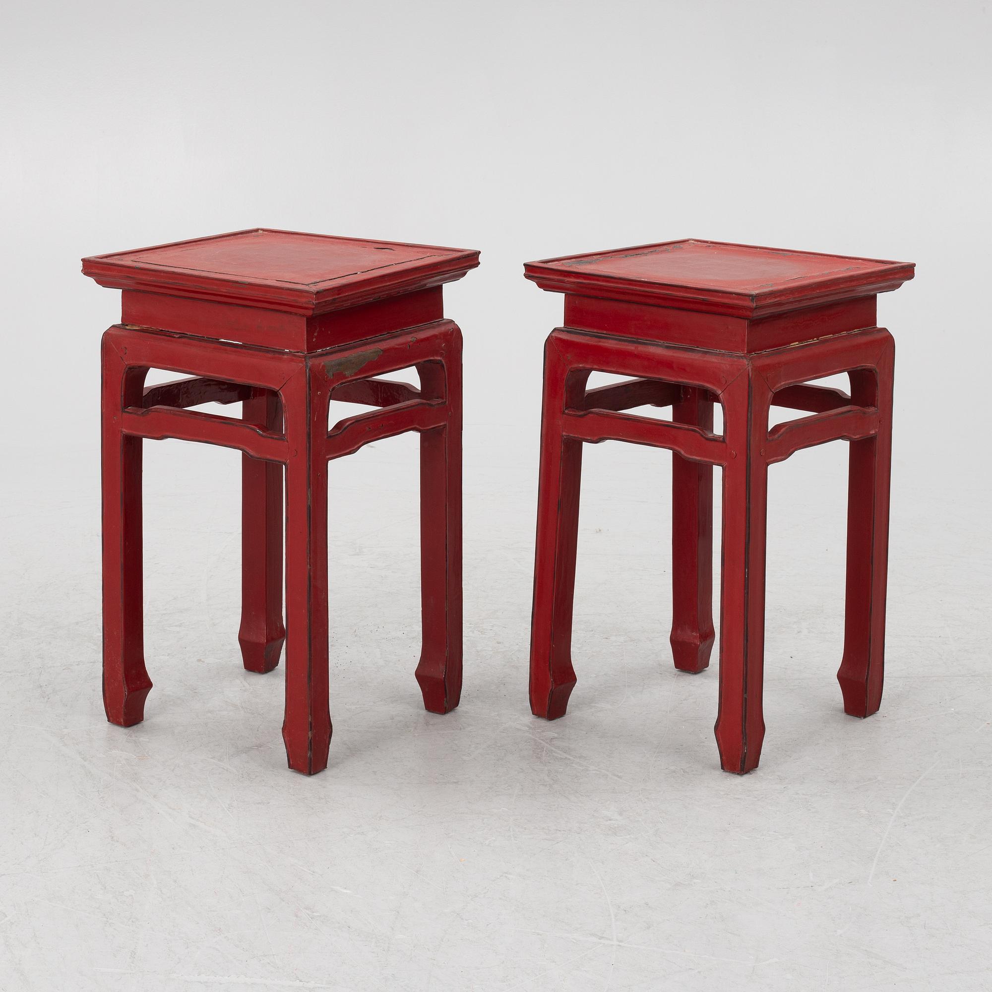 A pair of red Chinese small tables, 20th century.