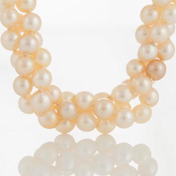 A three strand cultured pearl necklace.