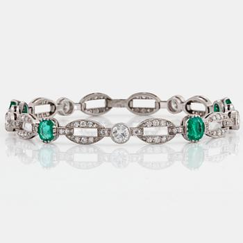 An 18K white gold bracelet set with faceted emeralds.