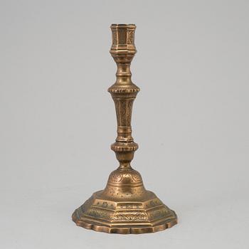 A 18th century bronze candlestick.