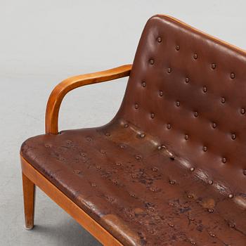 An Axel Larsson stained beech leather upholstered sofa, Svenska Möbelfabrikerna Bodafors, 1930's.