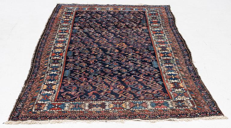 An oriental rug, c. 232 x 125 cm.