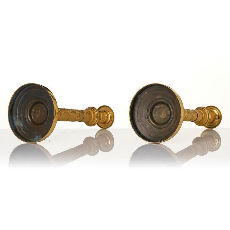 A pair of French Empire gilt-bronze candlesticks, early 19th century.