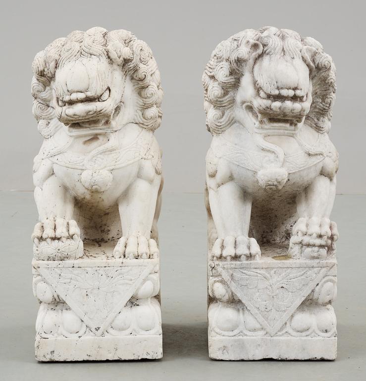 A pair of marble figures of 'Buddhist Lions', China.