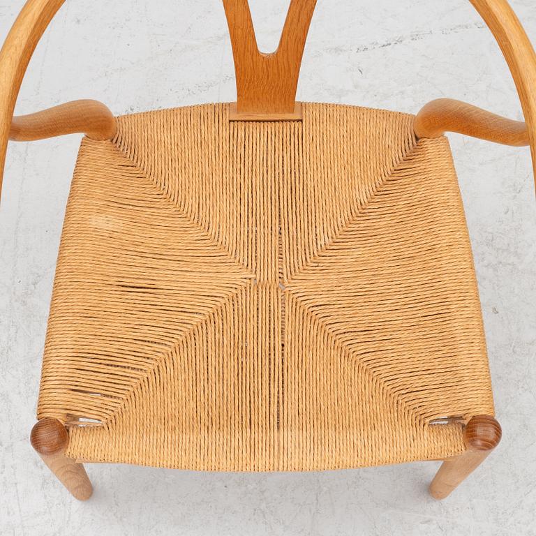 Hans J. Wegner, four model CH-24/ 'Wishbone' chairs, Carl Hansen, Odense, Denmark, second half of the 20th century.