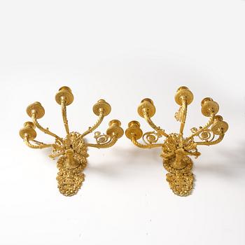 102. A pair of French Empire ormolu five-branch wall-lights, Paris, early 19th century.