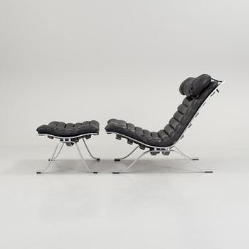 A black leather "Ari" easy chair with foot stool by Arne Norell for Norell möbler.