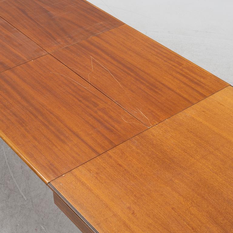 A 1950's/60's mahogany and mahogany veneered dining table.