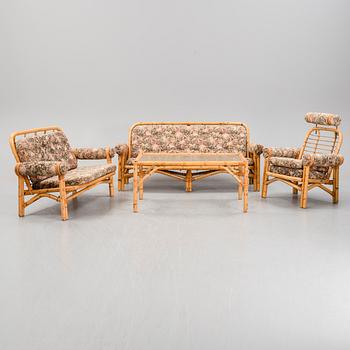 A set of two garden sofas, an armchair and a glass table, later part of the 20th Century.