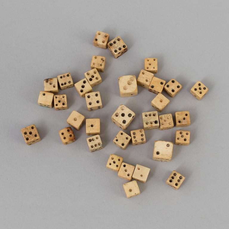 A COLLECTION OF 34 BONE MINIATURE DICE.