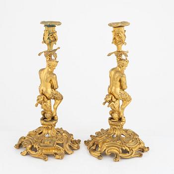 A pair of French gilt-bronze Louis XV-style candlesticks, late 19th century.