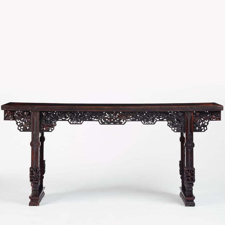 A massive zitan recessed-leg long table 'Jiaotousun Qiotouan', Qing dynasty, 19th century.