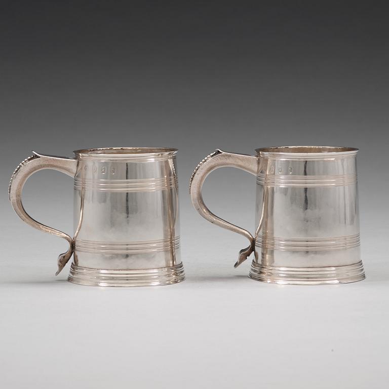 A pair of English early 18th century silver muggs, mark of John Cory, London 1704.