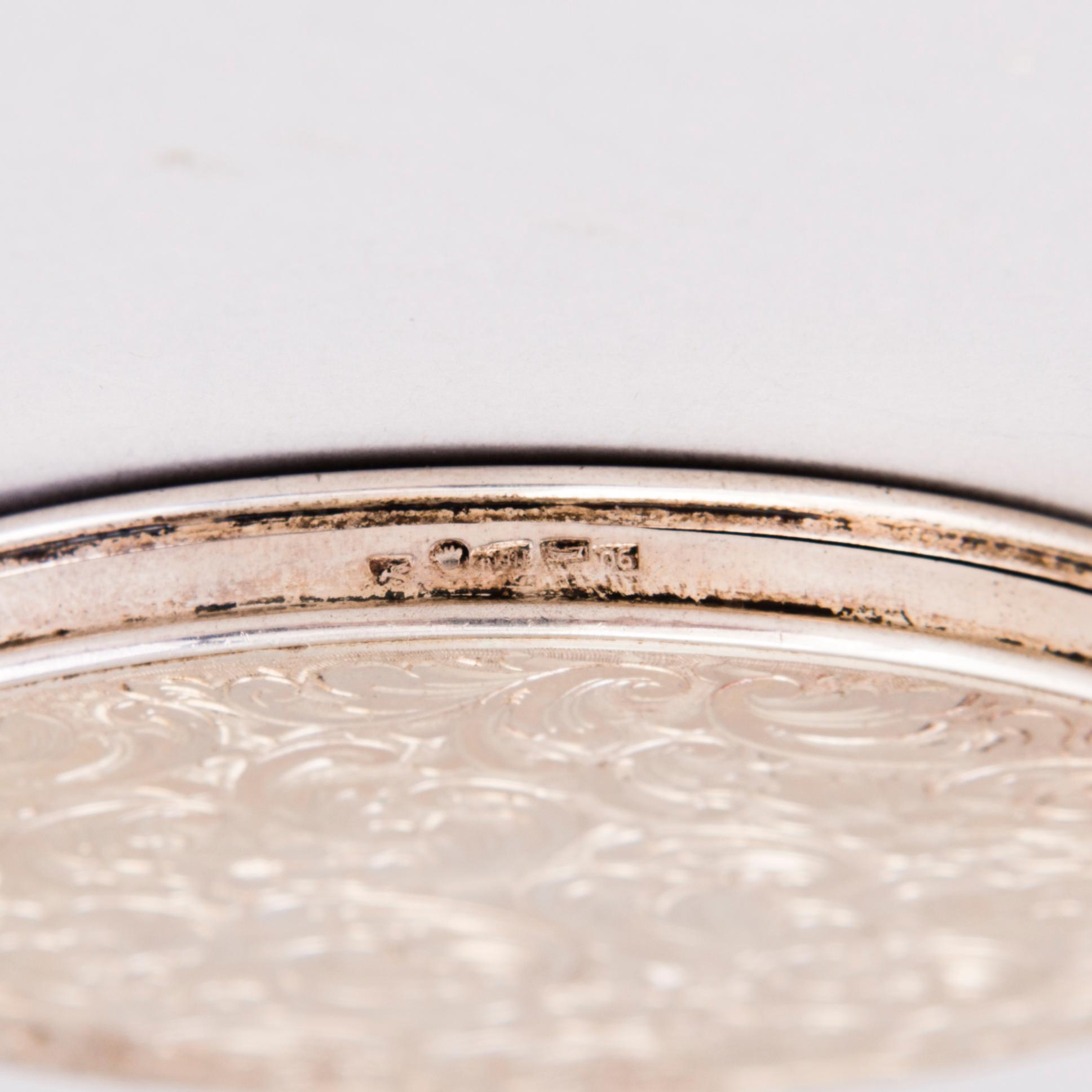 Two silver evening bags and a silver mirror, 1920s-1940s.