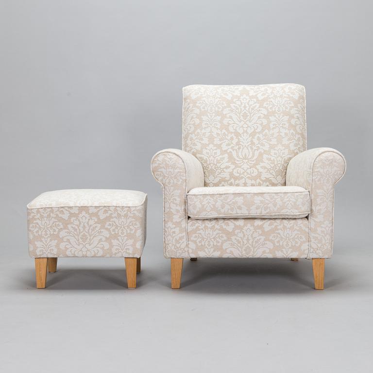 A mid-20th-century armchair and ottoman.