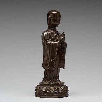 A bronze figure of a standing buddha, late Ming dynasty (1368-1644).