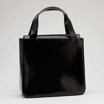 CÉLINE, a black patent leather purse.