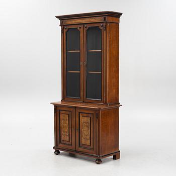 A mahogany veneered book cabinet, around 1900.