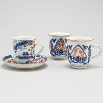 A pair of imari cups and a cup and saucer, Qing dynasty, 18th century.