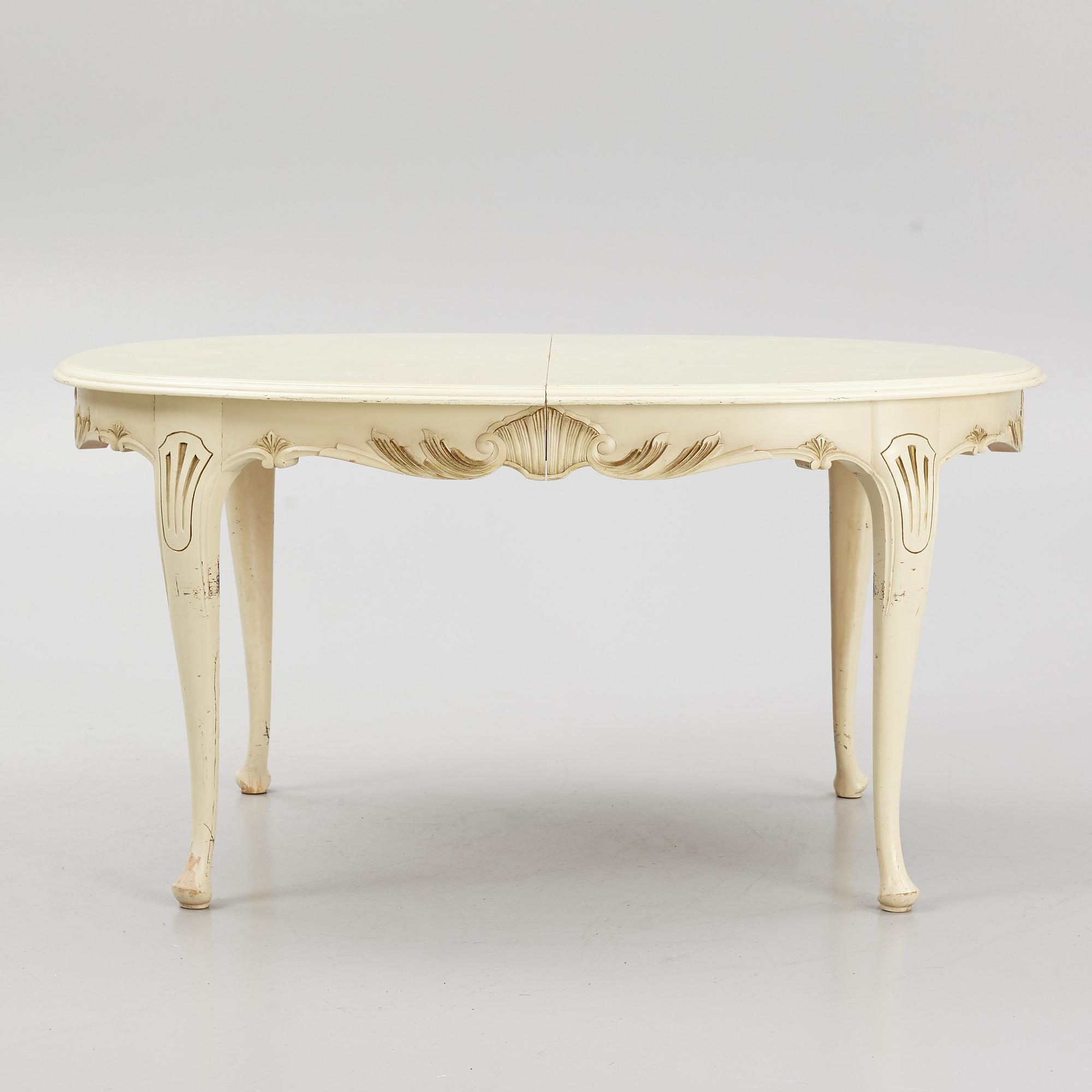 A Rococo style Dining Table with Chairs, first half of the 20th Century.