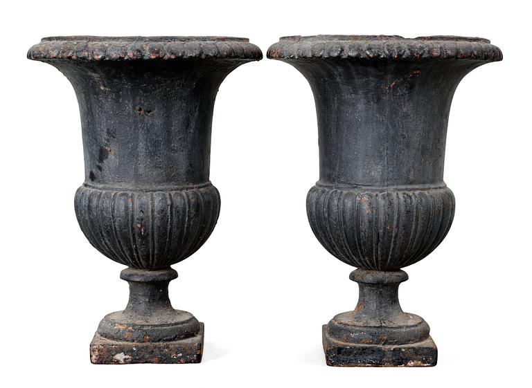 A pair of Empire first half 19th Century cast iron garden urns.