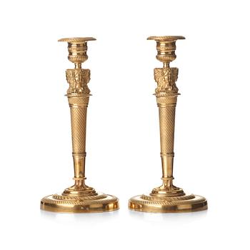 A pair of French Empire early 19th century gilt bronze candlesticks.