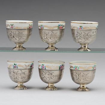 A set of six Ottoman parcel-gilt silver Xarfs with Russian Kuznetzov porcelain cups, c. 1910.